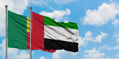 Benin and United Arab Emirates flag waving in the wind against white cloudy blue sky together. Diplomacy concept, international relations.