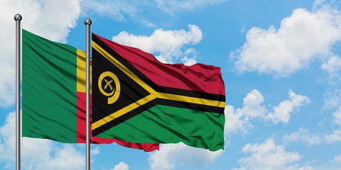Benin and Vanuatu flag waving in the wind against white cloudy blue sky together. Diplomacy concept, international relations.