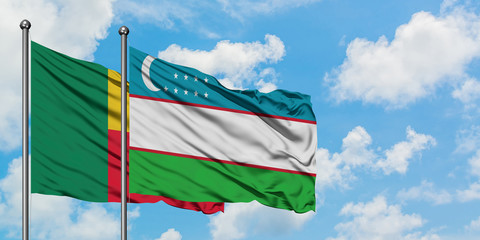 Benin and Uzbekistan flag waving in the wind against white cloudy blue sky together. Diplomacy concept, international relations.