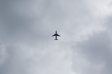 Naklejka na ściany i meble The plane is landing. Cloudy sky, bottom view