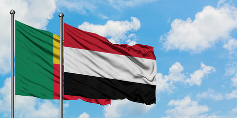 Benin and Yemen flag waving in the wind against white cloudy blue sky together. Diplomacy concept, international relations.
