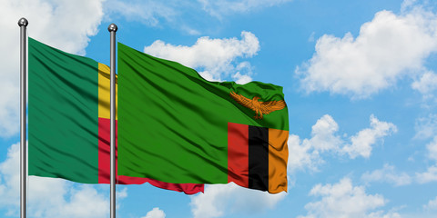 Benin and Zambia flag waving in the wind against white cloudy blue sky together. Diplomacy concept, international relations.