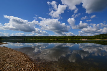 Mysterious north river Vishera lies beneath the  clouds and blue sky and flows to south