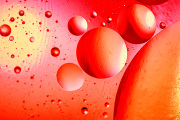 Abstract background with colorful gradient colors. Oil drops in water abstract psychedelic pattern image. Red colored abstract pattern