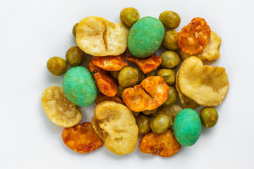 Japanese spicy appetizers with peanuts and wasabi lie in the center on a white background