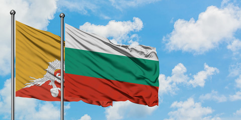 Bhutan and Bulgaria flag waving in the wind against white cloudy blue sky together. Diplomacy concept, international relations.