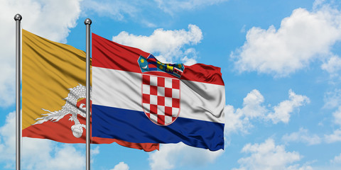 Bhutan and Croatia flag waving in the wind against white cloudy blue sky together. Diplomacy concept, international relations.