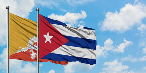 Bhutan and Cuba flag waving in the wind against white cloudy blue sky together. Diplomacy concept, international relations.