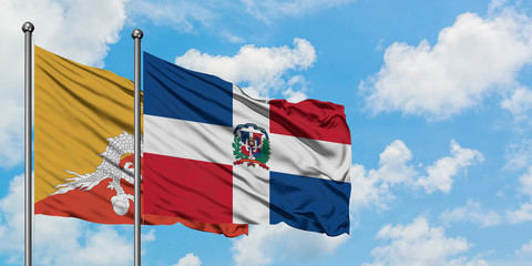 Bhutan and Dominican Republic flag waving in the wind against white cloudy blue sky together. Diplomacy concept, international relations.