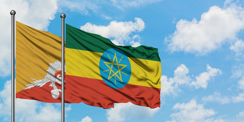 Bhutan and Ethiopia flag waving in the wind against white cloudy blue sky together. Diplomacy concept, international relations.
