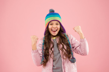 happy me. warm clothes for cold season. small girl winter hat. ready for winter activity. kid fashion. trendy girl smiling. child feel success pink background. autumn style. happy childhood