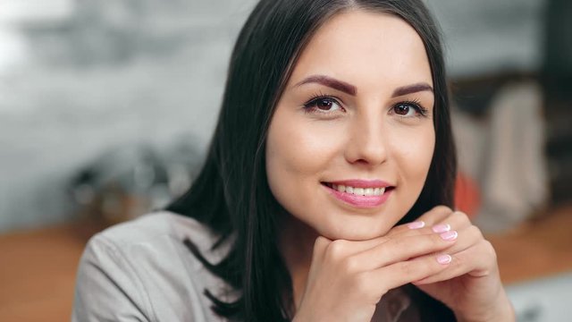 Close-up portrait of smiling charming young woman with perfect skin and natural makeup