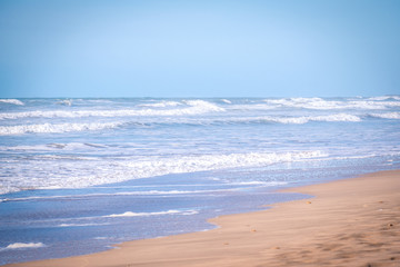 Fototapeta na wymiar Sandy coast of the Atlantic Ocean and surf waves in Morocco