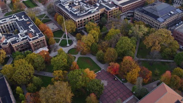 Ann Arbor Michigan Aerial v21 Slow panning birdseye over plaza, commons near Hatcher Graduate Library, with flag pole center - October 2017