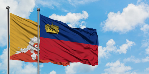 Bhutan and Liechtenstein flag waving in the wind against white cloudy blue sky together. Diplomacy concept, international relations.