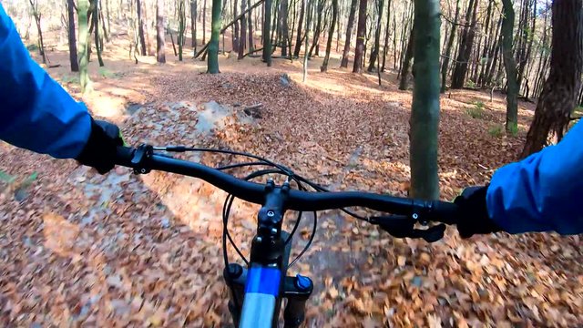 Amateur rider on the enduro bike riding on the trail in the autumn season
