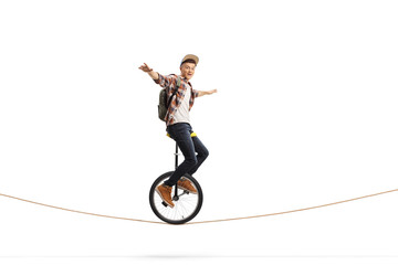 Male teenager riding a unicycle