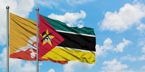 Bhutan and Mozambique flag waving in the wind against white cloudy blue sky together. Diplomacy concept, international relations.