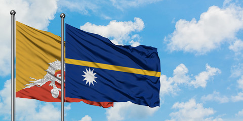 Bhutan and Nauru flag waving in the wind against white cloudy blue sky together. Diplomacy concept, international relations.