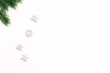 Christmas holiday composition of fir branches and snowflakes on a white background. minimalistic holiday concept