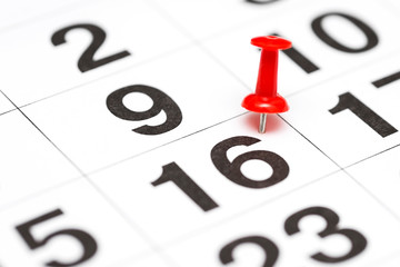 Pin on the date number 16. Sixteen day of month is marked with red thumbtack on calendar. Save the...