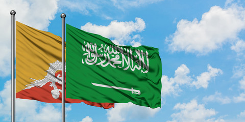 Bhutan and Saudi Arabia flag waving in the wind against white cloudy blue sky together. Diplomacy concept, international relations.