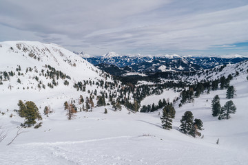 Fototapeta na wymiar Beautiful winter alpine mountain landscape of Niedere Tauern. Alpine landscape covered with snow, high alpine peaks near Hohetauern ski resort, Austria. Mountains in winter, blue sky, ski touring.