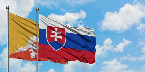 Bhutan and Slovakia flag waving in the wind against white cloudy blue sky together. Diplomacy concept, international relations.
