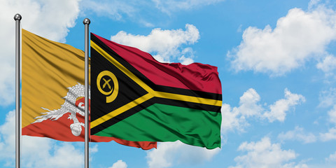 Bhutan and Vanuatu flag waving in the wind against white cloudy blue sky together. Diplomacy...