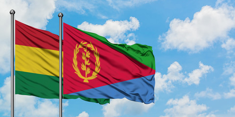 Bolivia and Eritrea flag waving in the wind against white cloudy blue sky together. Diplomacy concept, international relations.