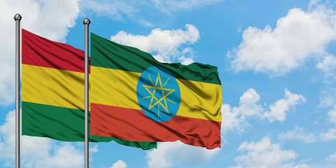 Bolivia and Ethiopia flag waving in the wind against white cloudy blue sky together. Diplomacy concept, international relations.