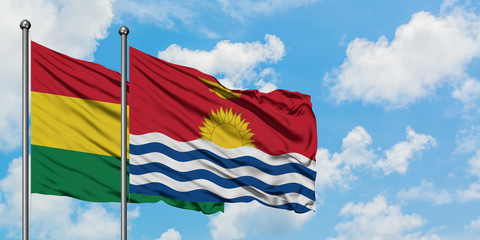 Bolivia and Kiribati flag waving in the wind against white cloudy blue sky together. Diplomacy concept, international relations.