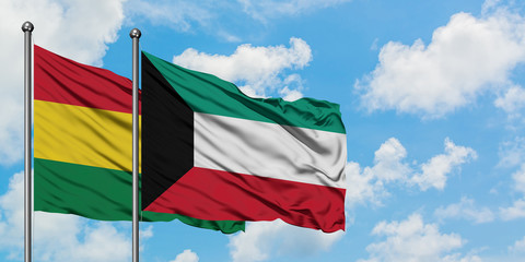 Bolivia and Kuwait flag waving in the wind against white cloudy blue sky together. Diplomacy concept, international relations.