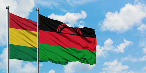 Bolivia and Malawi flag waving in the wind against white cloudy blue sky together. Diplomacy concept, international relations.