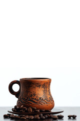 Old arabic coffee mug and coffee beans. Free space for inscription. Vertical