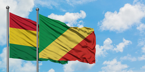 Bolivia and Republic Of The Congo flag waving in the wind against white cloudy blue sky together. Diplomacy concept, international relations.