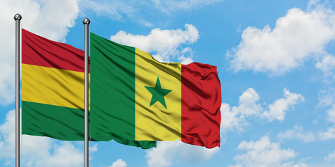 Bolivia and Senegal flag waving in the wind against white cloudy blue sky together. Diplomacy concept, international relations.