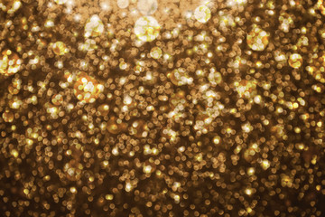Abstract gold glitter lights background. defocused