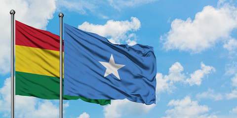 Bolivia and Somalia flag waving in the wind against white cloudy blue sky together. Diplomacy concept, international relations.