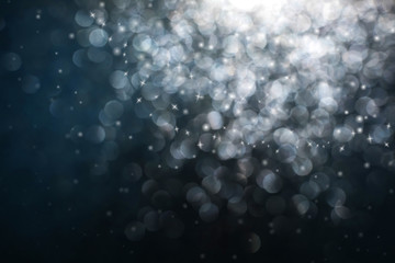 Dark blue glitter and lights bokeh abstract background. Holiday concept
