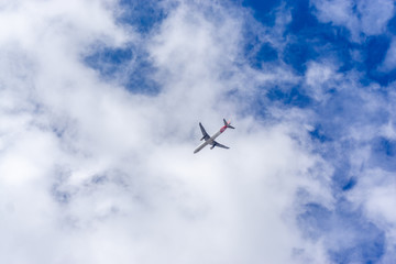 Airplane in the sky. Commercial airplane jetliner, travel and business concept.