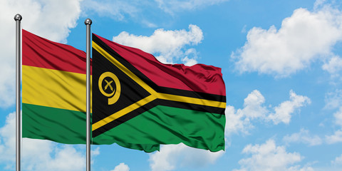 Bolivia and Vanuatu flag waving in the wind against white cloudy blue sky together. Diplomacy concept, international relations.