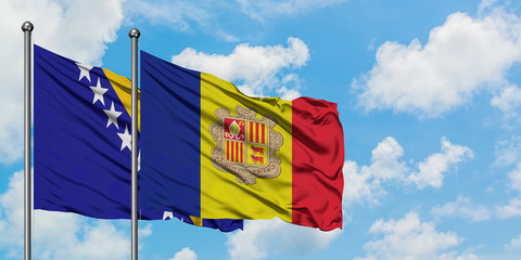 Bosnia Herzegovina and Andorra flag waving in the wind against white cloudy blue sky together. Diplomacy concept, international relations.