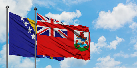 Bosnia Herzegovina and Bermuda flag waving in the wind against white cloudy blue sky together....