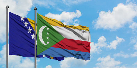 Bosnia Herzegovina and Comoros flag waving in the wind against white cloudy blue sky together. Diplomacy concept, international relations.
