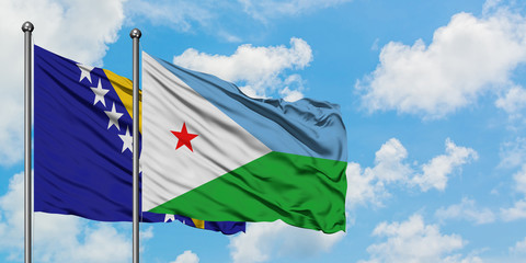 Bosnia Herzegovina and Djibouti flag waving in the wind against white cloudy blue sky together. Diplomacy concept, international relations.