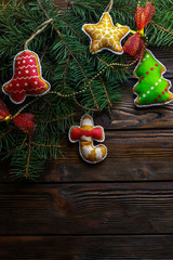 Beautiful Christmas toys with fir tree twigs on wooden background. With space for text