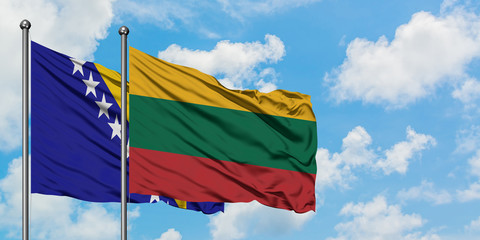 Bosnia Herzegovina and Lithuania flag waving in the wind against white cloudy blue sky together. Diplomacy concept, international relations.