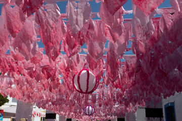 Street fully decorated with multicolored paper in Redondo village, Portugal.