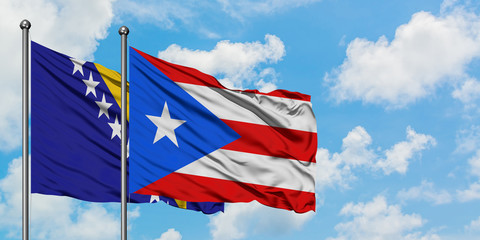 Bosnia Herzegovina and Puerto Rico flag waving in the wind against white cloudy blue sky together. Diplomacy concept, international relations.